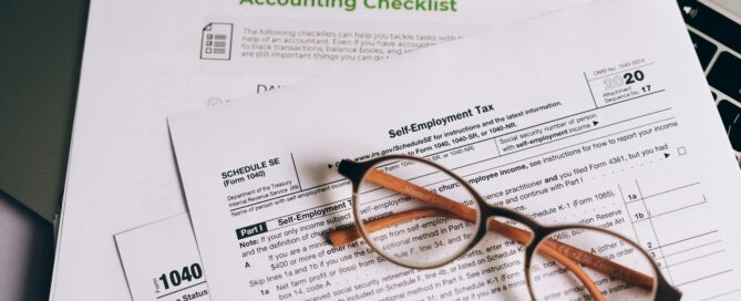 small business bookkeeper - glasses over tax forms