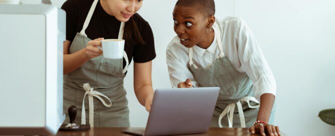 kitchen staff reading work notices on a lap top
