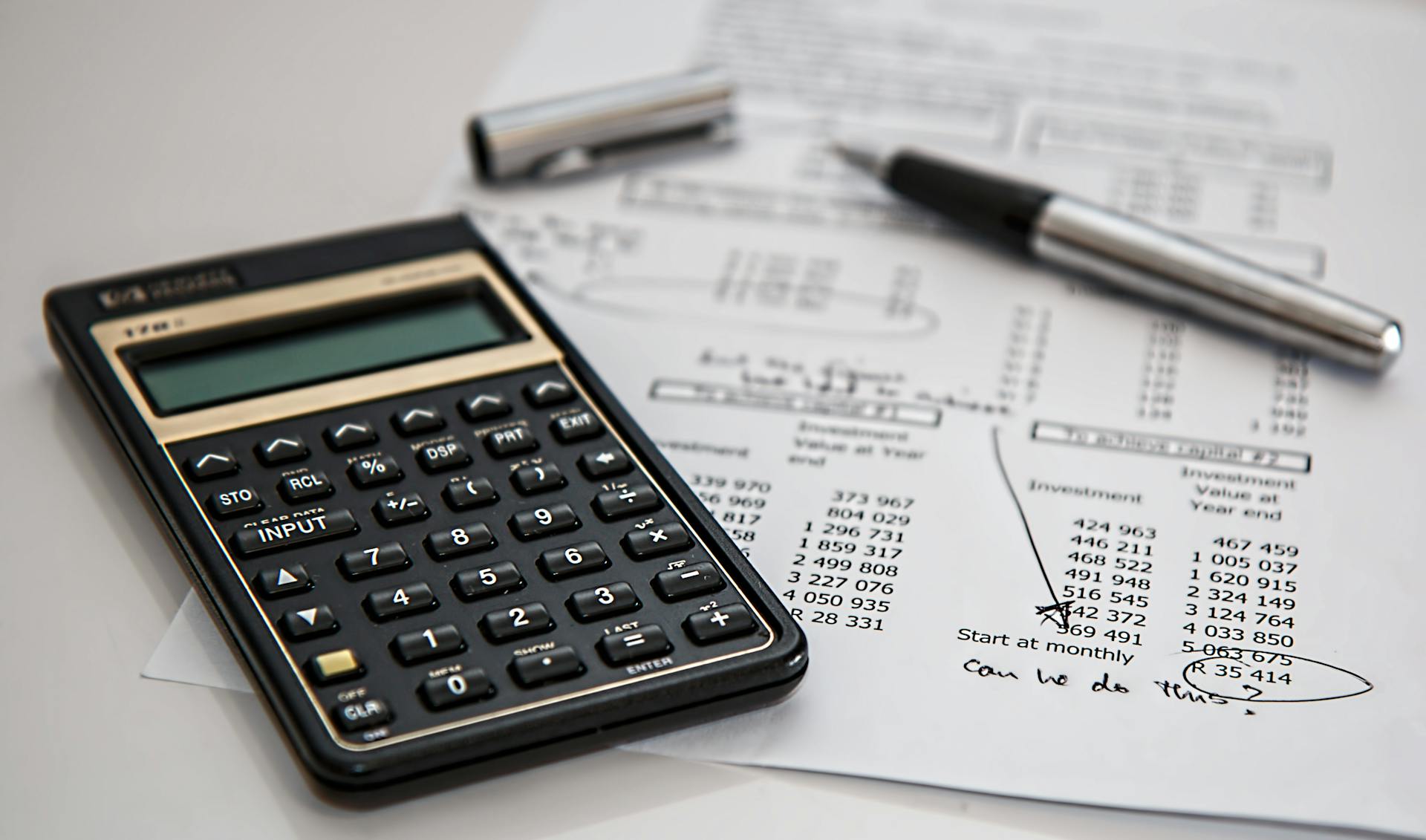bookkeeping tools, pen, calculator, and balance forms
